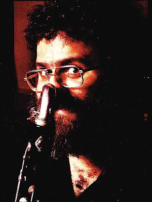 David Ocker, bearded and pixy-faced, playing the bass clarinet, circa 1983