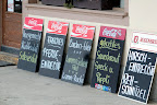 More clapboards advertising local specialties.