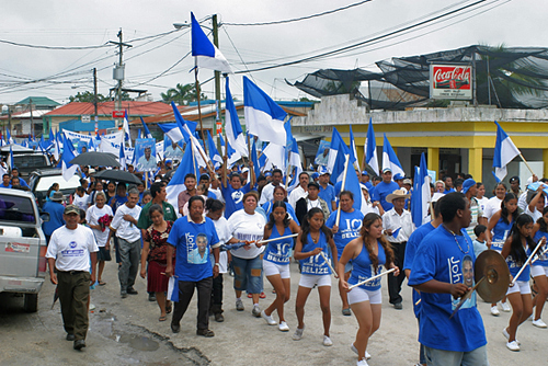People United Party (PUP) candidates and supporters march.