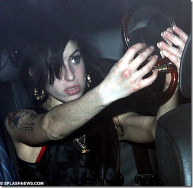 Amy Winehouse tries to smarten herself up to visit Blake in the back of a car 1