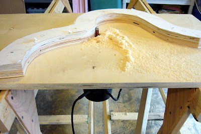Home-made router table with acoustic bass guitar mold pattern