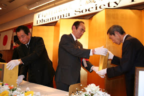 Japanese  Dhamma Society Patrons hand-carry Roman-script Tipitaka to be placed on high table, Osaka, 2007.  