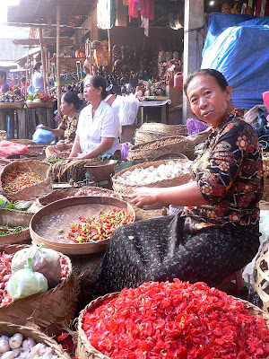 Proprietress, vegetable and flower stall, Ubud market