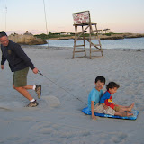 Paul pulling Kai and Eidan across the sand