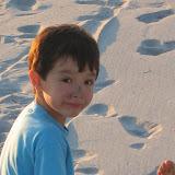 Kai on the beach with charcoal on his nose