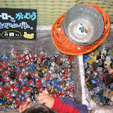 Bins of Ultraman finger puppets at the Ultraman store under Tokyo station. The sign says â€œDon't mix the heroes and the monsters! Please.â€