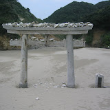 A shrine gate at Chikura Caverns, Tanegashima. We saw folks trying to toss rocks and shells onto it.
