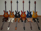 The PRS collection as of March 2008... L to R back: Custom 22 semi-hollow (tobacco sunburst), Custom 24 (violin amber burst), Custom 24 (gray black), Custom 24 (cherry sunburst), Custom 24 (whale blue), Custom 22 (vintage yellow); L to R front: Mira (vintage cherry), Standard 24 (cream), 513 Mahogany (vintage natural), Singlecut (black sunburst), McCarty Rosewood (natural), McCarty Soapbar (black w/ natural binding)