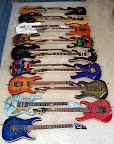 My Ibanez collection as of Sept 2003... F to B: RG2420-TB Prestige, RG3120-DR Prestige, Jem90-HAM, RG1880-BGS J-Custom, RG7CT-VV Prestige, RG770FM-DBL, JPM100-P2, UV777-BK Universe, RG421-RB, JPM100-P1, RG-ART J-Custom, RG1220QM-TO USA Custom, Jem7-VWH, MA1FM American Master, RG3120-TW Prestige, RGT3120-TV Prestige, RG1680x-AM J-Custom