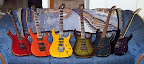 My Ibanez “rainbow collection” as of May 2002... L to R: RG3120-DR Prestige, RG1220QM-TO USA Custom, RG1680x-AM J-Custom, RG1880-BGS J-Custom, RG3120-TW Prestige, RGT3120-TV Prestige
